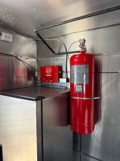 Buckeye Kitchen Mister fire suppression system installed in a commercial kitchen